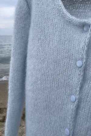 baby blue mohair sweater on front of sea water