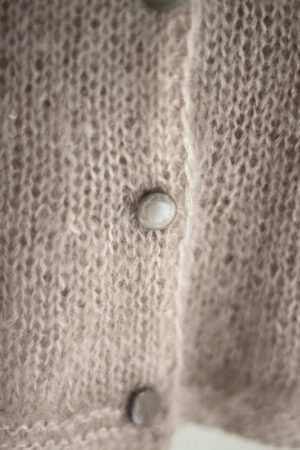 buttons of mohair sweater in powder color